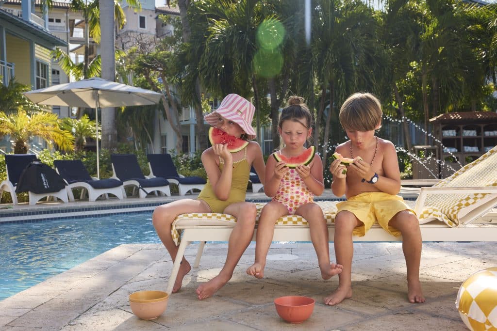 Kids enjoying watermelon by the pool at Beaches Turks and Caicos
